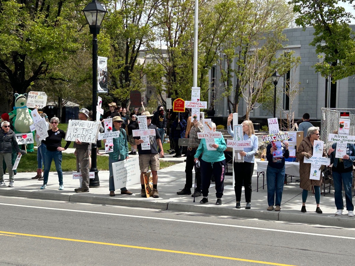 Rally participants holding memorial signs along the street