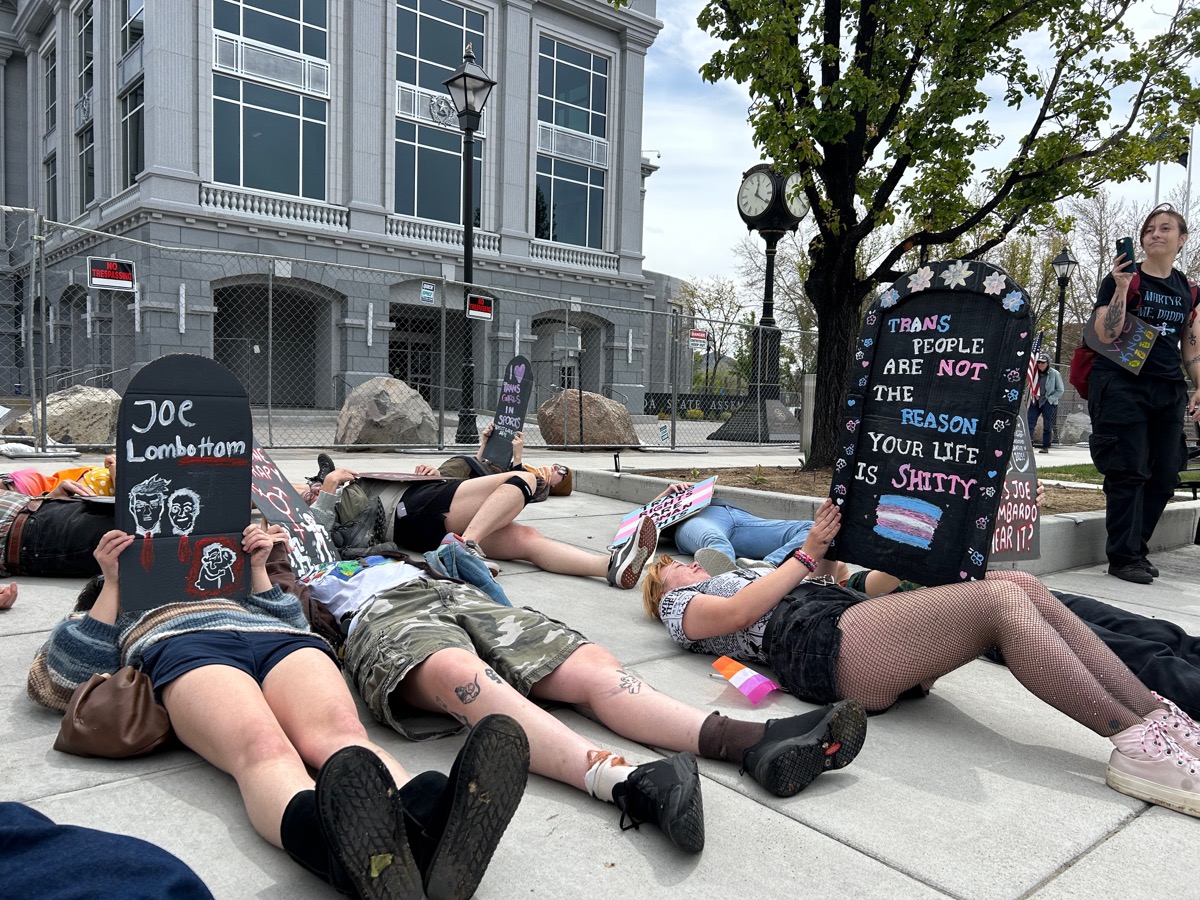 Protesters with artwork signs during die-in