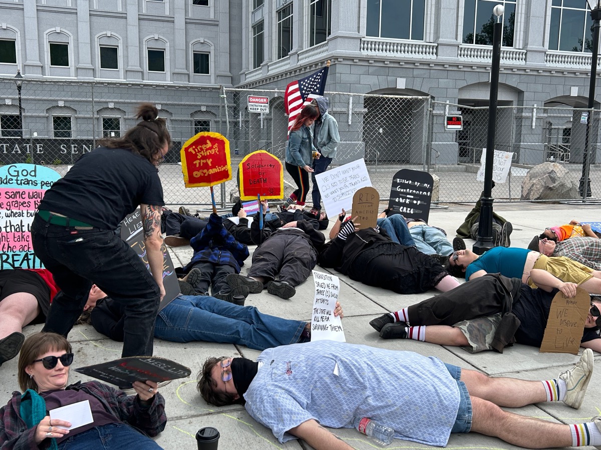 Die-in protest with American flag at the State Senate